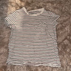 A cream color and burgundy and black colored shirt with a little pocket